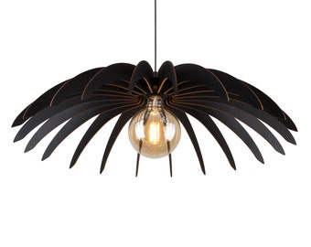 May include: Black pendant light fixture with a unique design resembling a palm tree. The light fixture has a round, clear glass shade with a warm light bulb.