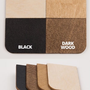 May include: Four wood samples in different finishes: natural unpainted, light wood, dark wood, and black. The samples are arranged in a grid pattern and are all the same size.