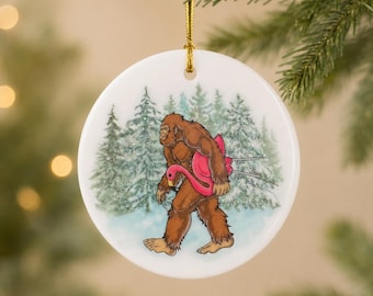 Bigfoot Flamingo Pool Float Ceramic Ornament | Funny Sasquatch Christmas Ornament | Hand Painted Glitter | 2.75 Inch Tree Decoration
