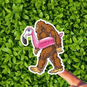 Bigfoot with a Flamingo Pool Float Vinyl  Sticker or Magnet / Fantasy / UFO / Cryptid / Last Podcast on the Left