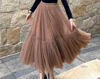 May include: A brown tulle skirt with black polka dots and a ruffled hem.