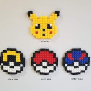 May include: Four pixel art figures of Pokemon characters: Pikachu, Poke Ball, Ultra Ball, and Great Ball. The figures are made of small plastic beads.