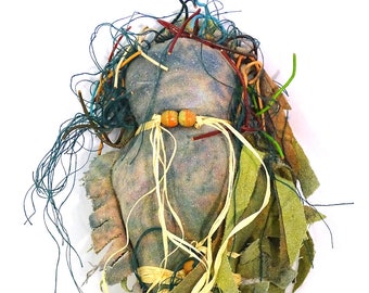 Oh Golly Dollie #6 is an Earth Mother made of dyed raw silk with raffia and bead accents.