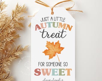 May include: A white gift tag with a colorful autumn treat design. The tag features a maple leaf and the text "Just a little autumn treat for someone so sweet. Love Sophia."