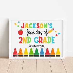 May include: A colorful printable sign that says "JACKSON'S first day of 2ND GRADE" with a red apple, a pencil, and stars. The sign also has a row of crayons at the bottom with the text "Date here 20XX".