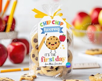 May include: A colorful printable gift tag with a cartoon cookie holding a pencil and an apple. The tag says "Chip Chip Hooray! It's the first day. Love Mrs. Sanchez".