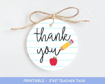 May include: Printable 2x2 inch teacher thank you tags with a pencil and apple design on a blue lined paper background.