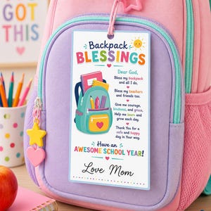May include: A rectangular white tag attached to a pink and purple backpack with a pink star charm. The tag features the text Backpack BLESSINGS, a prayer, and the text Have an AWESOME SCHOOL YEAR! Love Mom, alongside a graphic of a teal backpack.