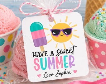 May include: A square white gift tag tied with pink and white twine, featuring a colorful popsicle, a yellow sun wearing purple sunglasses, and the text HAVE A SWEET SUMMER Love Sophia in black, pink, teal, and purple lettering on the front.