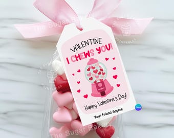 May include: A pink and white Valentine's Day gift tag with a gumball machine illustration and the text "Valentine I Chews You!"  The tag is attached to a clear plastic bag filled with pink and red heart-shaped candies. The text "Happy Valentine's Day! Your friend Sophie" is printed on the tag.