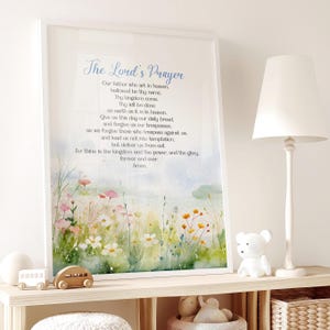 May include: A watercolor print of a field of flowers with the Lord's Prayer written in cursive script. The text is in a light blue color and the background is a soft blue and green.