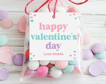 May include: A clear plastic bag filled with pastel-colored candy, tied with a red ribbon and a white tag that reads "happy valentine's day Love Amelia".