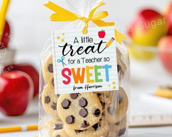 May include: A clear plastic bag filled with chocolate chip cookies tied with a yellow ribbon. A printable gift tag with the text "A little treat for a Teacher so SWEET from Harrison" is attached to the bag.