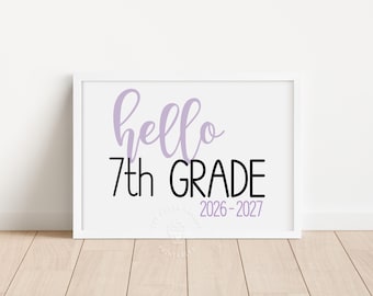 May include: A white rectangular frame containing a sign with the text hello in light purple script, 7th GRADE in bold black sans-serif letters, and the years 2026-2027 in light purple. The sign has a clean, simple design on a white background.