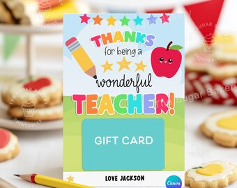 May include: A colorful gift card with a rainbow-colored "Teacher!" text, a red apple with a smiling face, and a pencil. The card says "Thanks for being a wonderful Teacher!" and has a space for a gift card. The card is signed "Love Jackson".