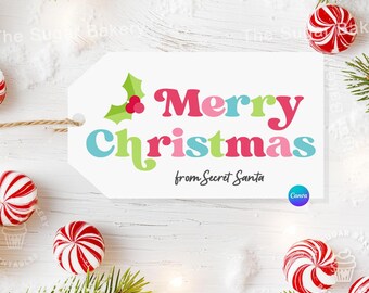 May include: White gift tag with the text "Merry Christmas" in colorful letters with a green holly sprig with a red berry. The text "from Secret Santa" is below the greeting.
