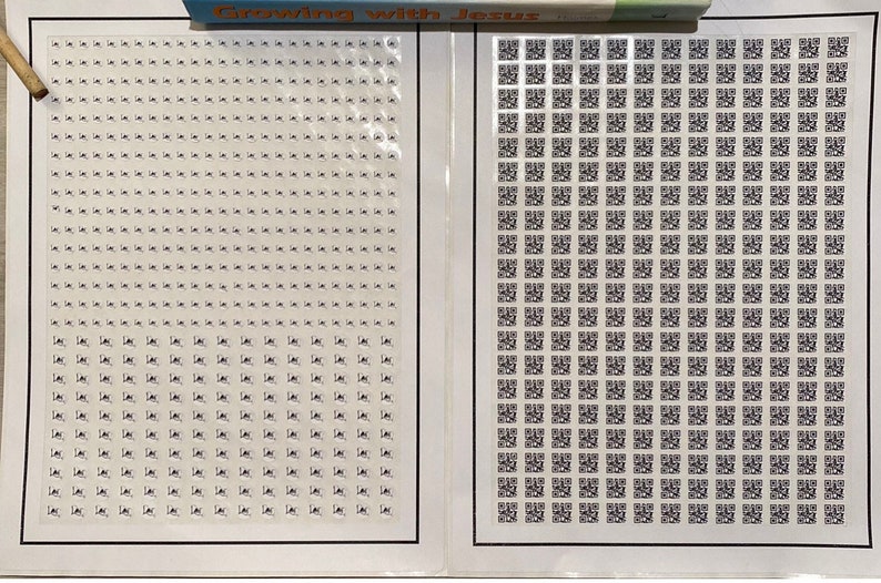 May include: Two rectangular sheets of adhesive labels with black borders. The left sheet contains numerous small, square white stickers with tiny black icons. The right sheet features a grid of small, square black and white QR code stickers.