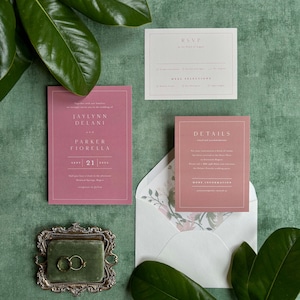 May include: A wedding invitation suite with a pink and white color scheme. The invitation card features the names "Jaylynn Delani and Parker Fiorella" and the date "Sept 21, 2024". The RSVP card has a section for meal selections. The details card includes information about the venue and accommodations.