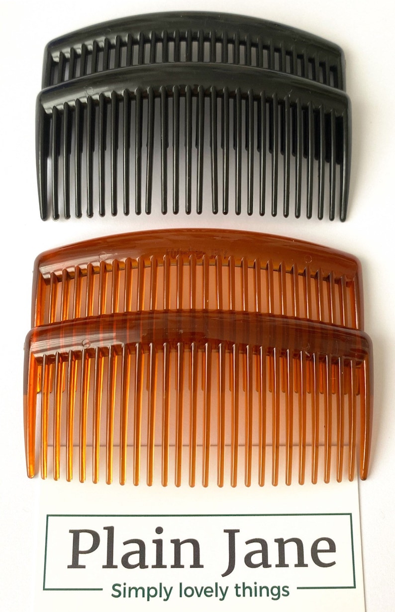 May include: Two sets of hair combs, one set is black and the other is brown. The combs are curved and have fine teeth. The combs are stacked on top of each other. The text "Plain Jane Simply lovely things" is visible at the bottom of the image.