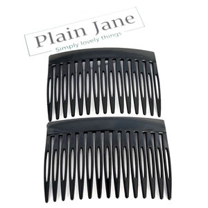 May include: Two black hair combs with multiple teeth, arranged one above the other. The combs have a curved top and are set against a white background. The text "Plain Jane Simply lovely things" is in the upper right corner.