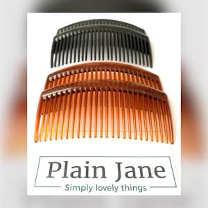 May include: Three plastic hair combs, two brown and one black, are stacked on top of each other. The combs are curved and have a wide tooth design.
