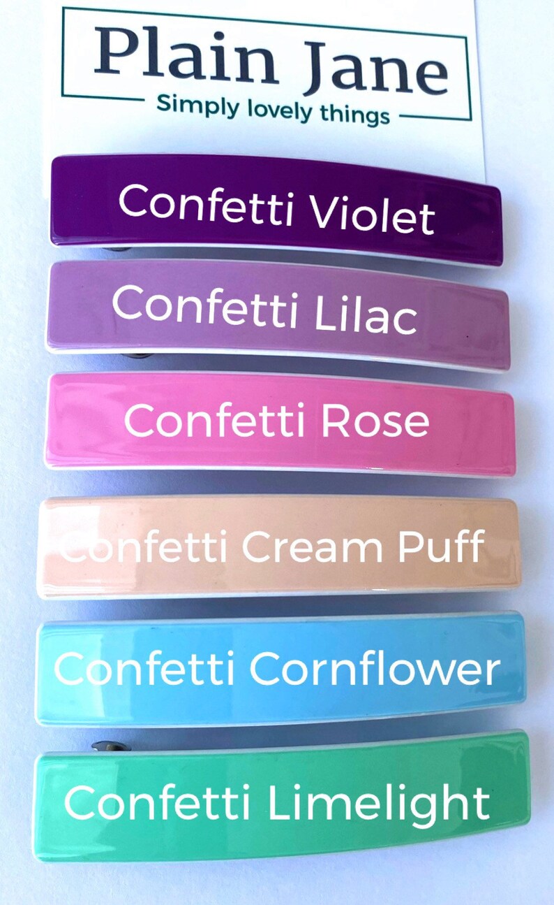 May include: Six colorful hair clips with the words "Confetti Violet", "Confetti Lilac", "Confetti Rose", "Confetti Cream Puff", "Confetti Cornflower", and "Confetti Limelight" printed on them.