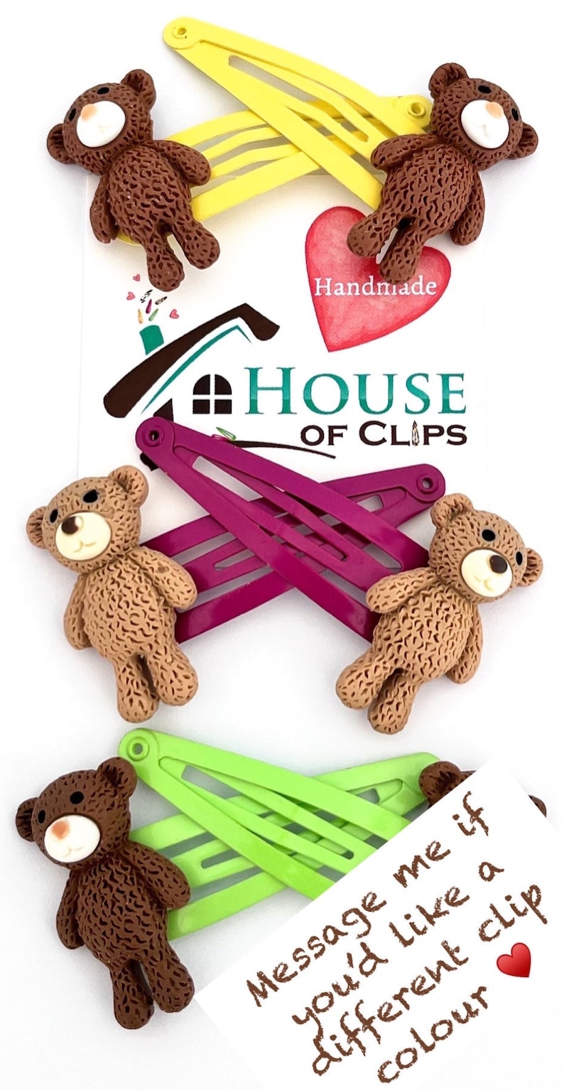 May include: Set of four brown teddy bear hair clips with yellow, green, and purple plastic barrettes. The clips are handmade and come with a note that says "Message me if you'd like a different clip colour".