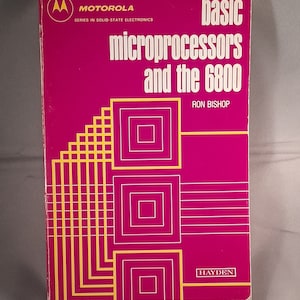 May include: A pink book titled "basic microprocessors and the 6800" by Ron Bishop. The book is part of the Motorola series in solid-state electronics and published by Hayden.