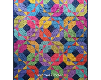 May include: A colourful crochet blanket with a geometric pattern in shades of blue, green, yellow, orange, pink, and purple. The blanket is made up of squares with a repeating pattern of triangles and circles. The blanket is made by Insomnia Crochet.