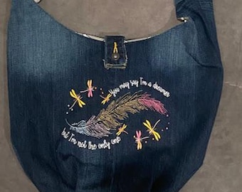 Embroidered Imagine Lyrics Crossbody Bag made from recycled jeans and lined with repurposed fabric. Two pockets inside, one zippered.