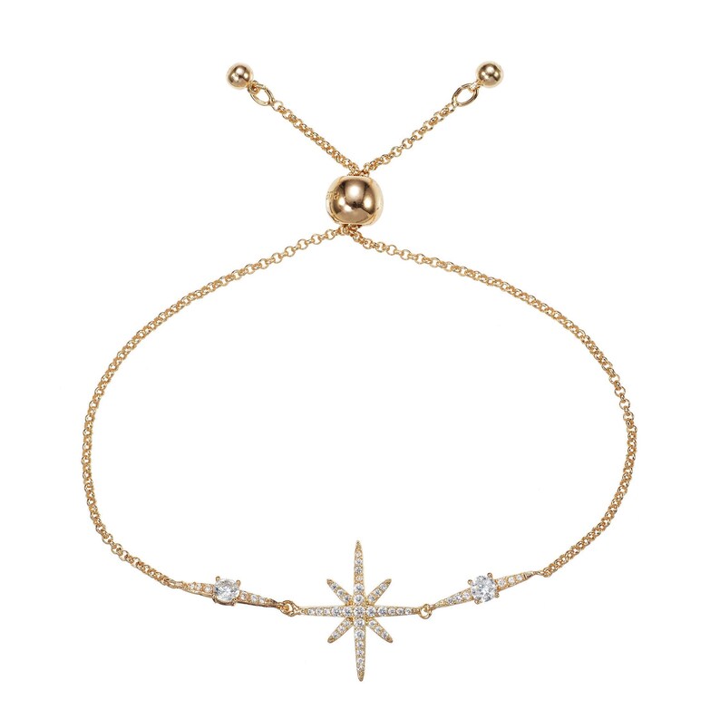 May include: A gold adjustable bracelet with a starburst charm and two smaller round charms, all set with clear cubic zirconia stones.