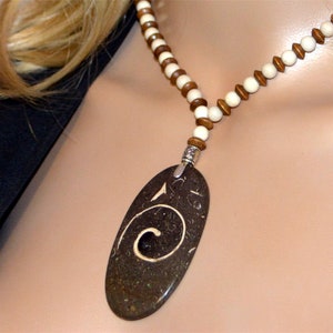 FOSSIL MARBLE pendant authentic ammonite shell coiled in a spiral. The ammonite symbol of infinite love. White marble wood beads