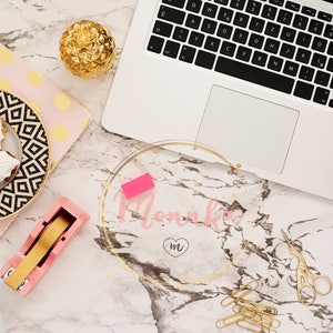 Styled Stock Photo. Feminine workplace concept in flat lay laptop, sweets, golden pineapple, notebook and paper clips on marble background