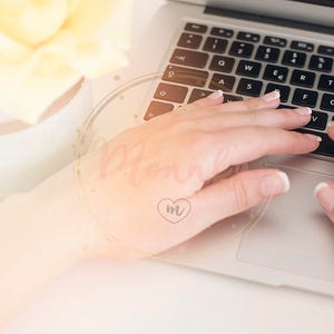 Styled Stock Photo. Feminine workplace concept. Freelance workspace with laptop, flowers, woman hand on macbook. Blogger working