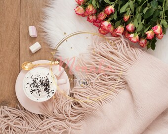 Styled Stock Photo. Cozy Winter Mornings. Cappuccino, bouquet of roses and a warm scarf on a white fur carpet on the floor.