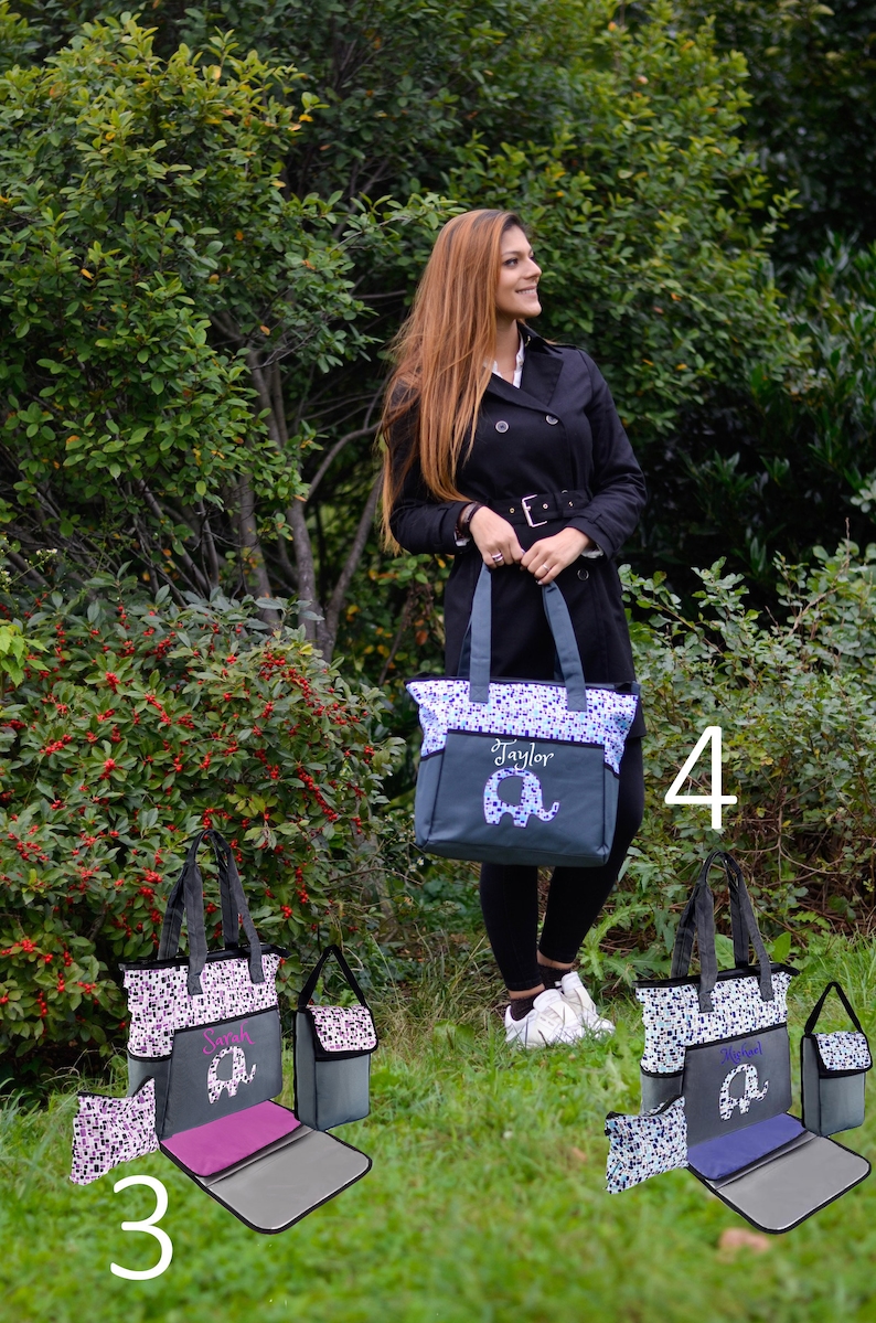 May include: Three gray and blue diaper bags with elephant designs and personalized names. The bags have multiple pockets and a changing pad. The bags are labeled with the numbers 3 and 4.