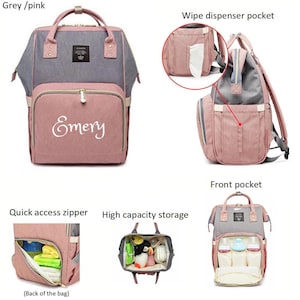 May include: A grey and pink diaper bag with multiple pockets and compartments. The bag has a zippered pocket on the back, a wipe dispenser pocket on the side, and a large front pocket. The bag is also personalized with the name "Emery".
