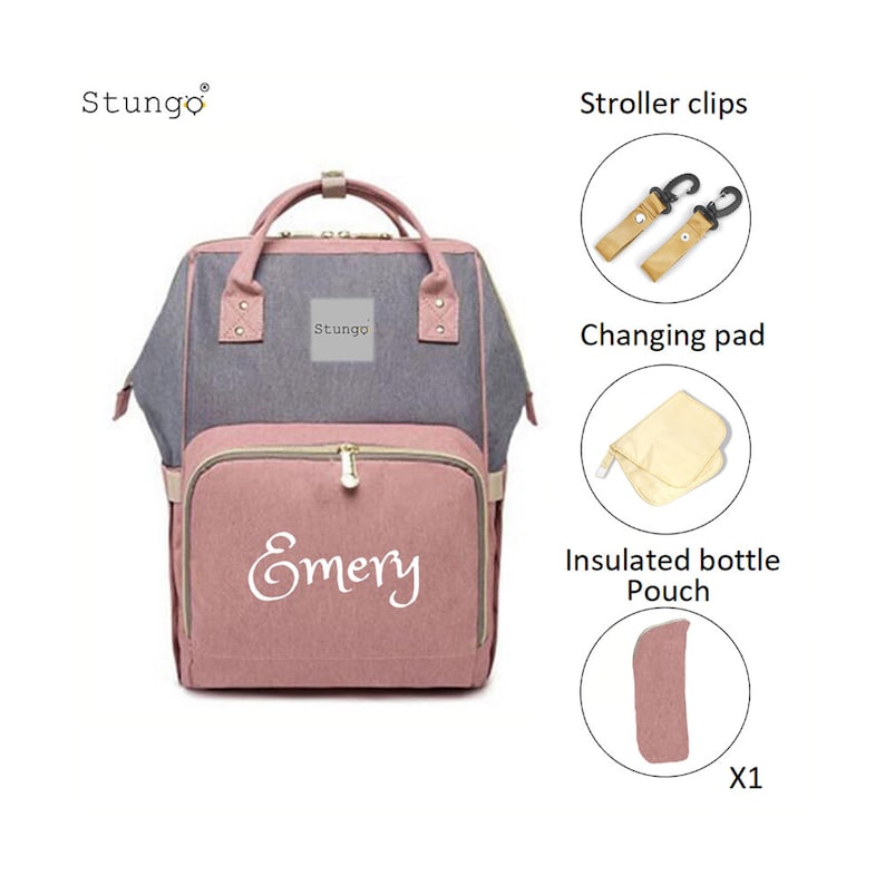 May include: A pink and gray diaper bag with the name "Emery" embroidered on the front. The bag comes with a changing pad, insulated bottle pouch, and stroller clips.