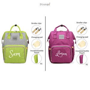 May include: Two diaper bags, one green and one purple, with the names "Sam" and "Logan" embroidered on them. Both bags have a changing pad, insulated bottle pouch, and stroller clips.