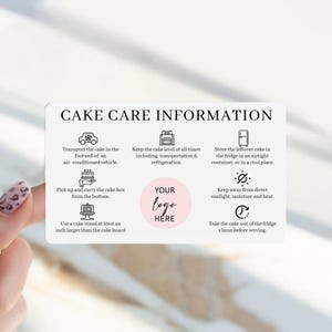 May include: A rectangular white card titled CAKE CARE INFORMATION with black text and icons. It provides instructions for transporting, storing, and serving cakes, including a central pink circle with the placeholder text YOUR LOGO HERE.