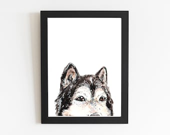 May include: A framed watercolour painting of a husky dog's face. The dog's fur is a mix of black, white, and grey, with brown eyes. The artwork is set against a white background and framed in a black rectangular frame.