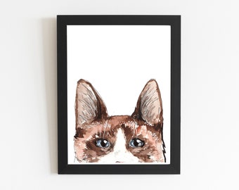 May include: A watercolor painting of a cat's face peeking over the top of a black frame. The cat has brown and white fur, blue eyes, and a white nose.