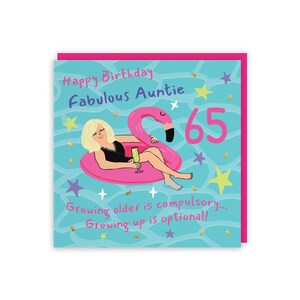 May include: A square birthday greeting card featuring a blonde character in a black swimsuit lounging on a pink flamingo pool float. The blue water background includes the text Happy Birthday Fabulous Auntie, the number 65, and the phrase Growing older is compulsory... Growing up is optional! with scattered yellow and purple stars.