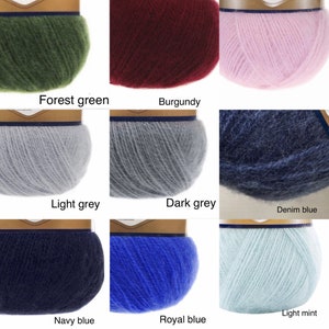 May include: Nine balls of yarn in different colours: forest green, burgundy, light grey, dark grey, denim blue, navy blue, royal blue, light mint, and pink.