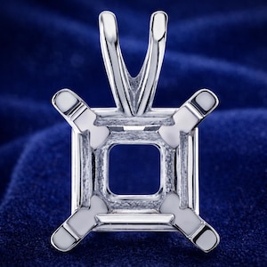 May include: A polished silver pendant setting with a square center and four prongs. The pendant has a bail at the top for a chain. The setting is designed to hold a square gemstone.