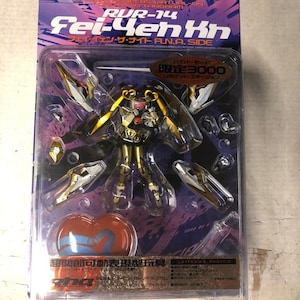 May include: A gold and white plastic action figure of a female character with long blonde hair and a pink and white outfit. The figure is holding a sword and has a heart-shaped base. The packaging is labeled "R.N.A. Side" and "RUR-14 Fei-Yen Kh".