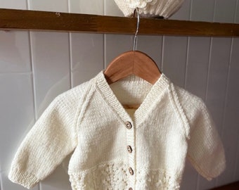 A Hand Knitted Wool Baby Cardigan and Beanie Set, 3-6 Months