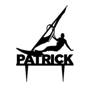 May include: Black silhouette cake topper depicting a windsurfer on a board with a sail. The name "PATRICK" is displayed in bold letters below the windsurfer, with two pointed stakes for insertion.