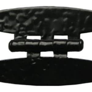 May include: Black metal hinge with a hammered finish and decorative pointed ends. The hinge is designed for use on doors or gates.