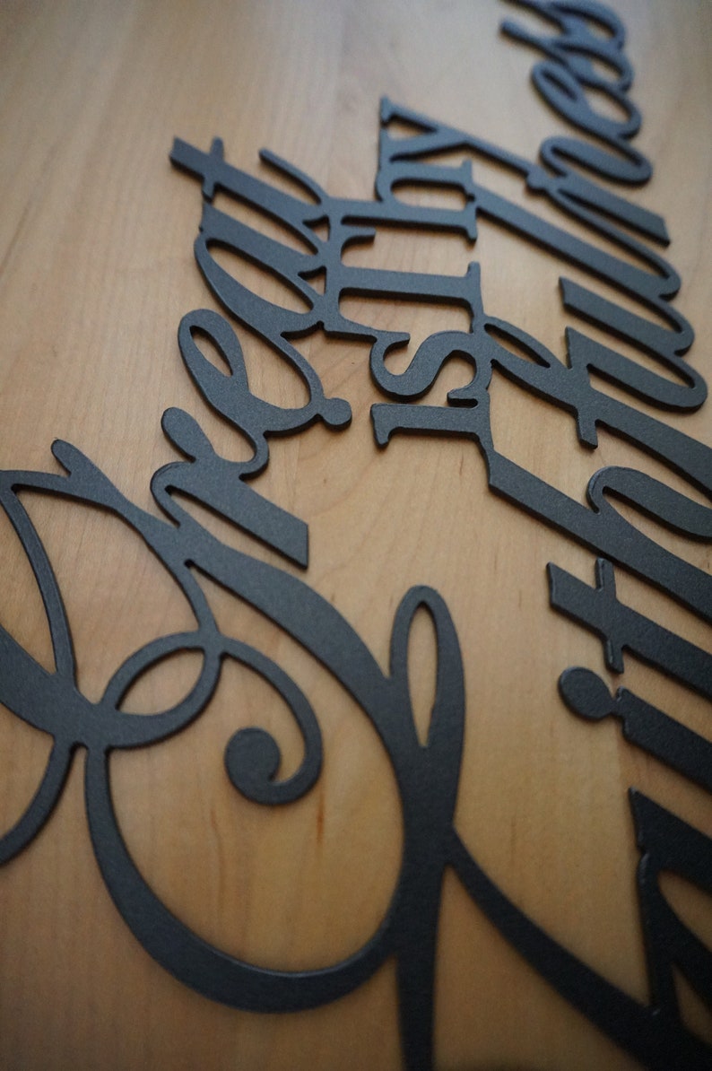 close up of cut metal sign